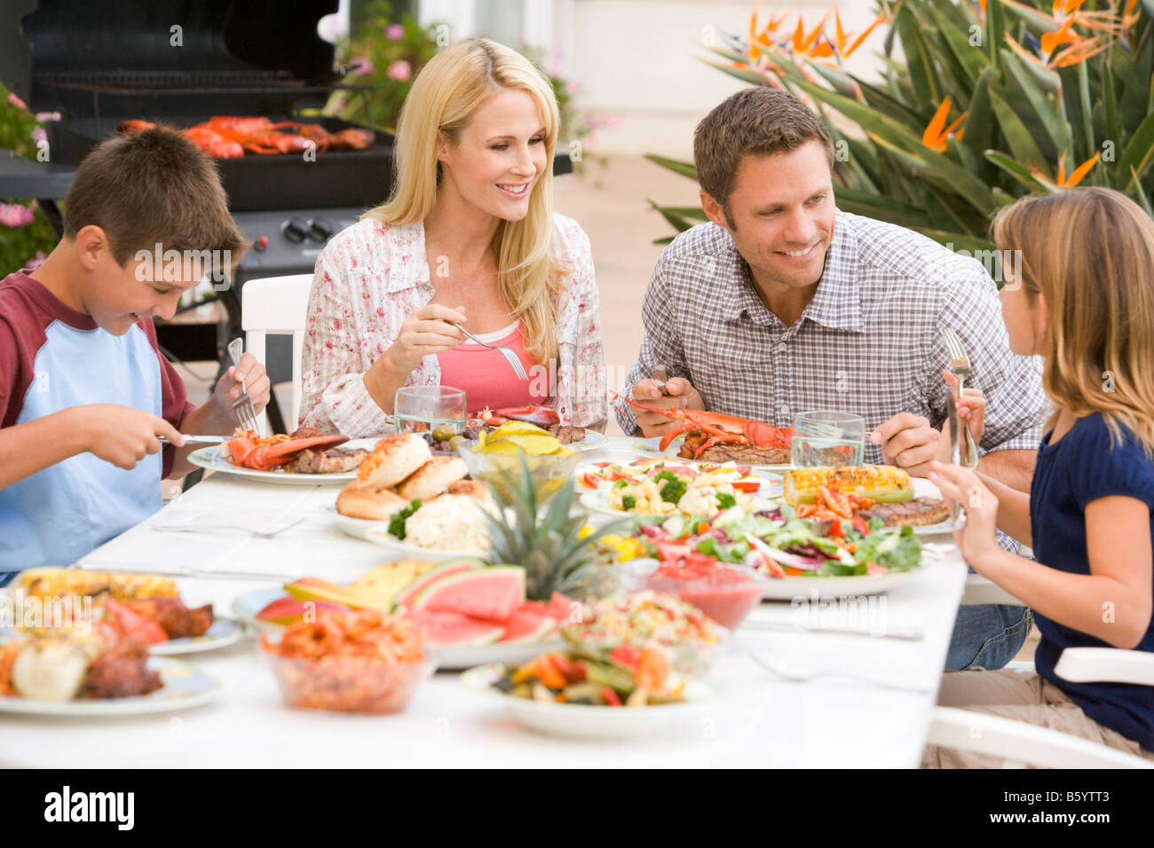 Family Enjoying A Barbeque Stock Photo