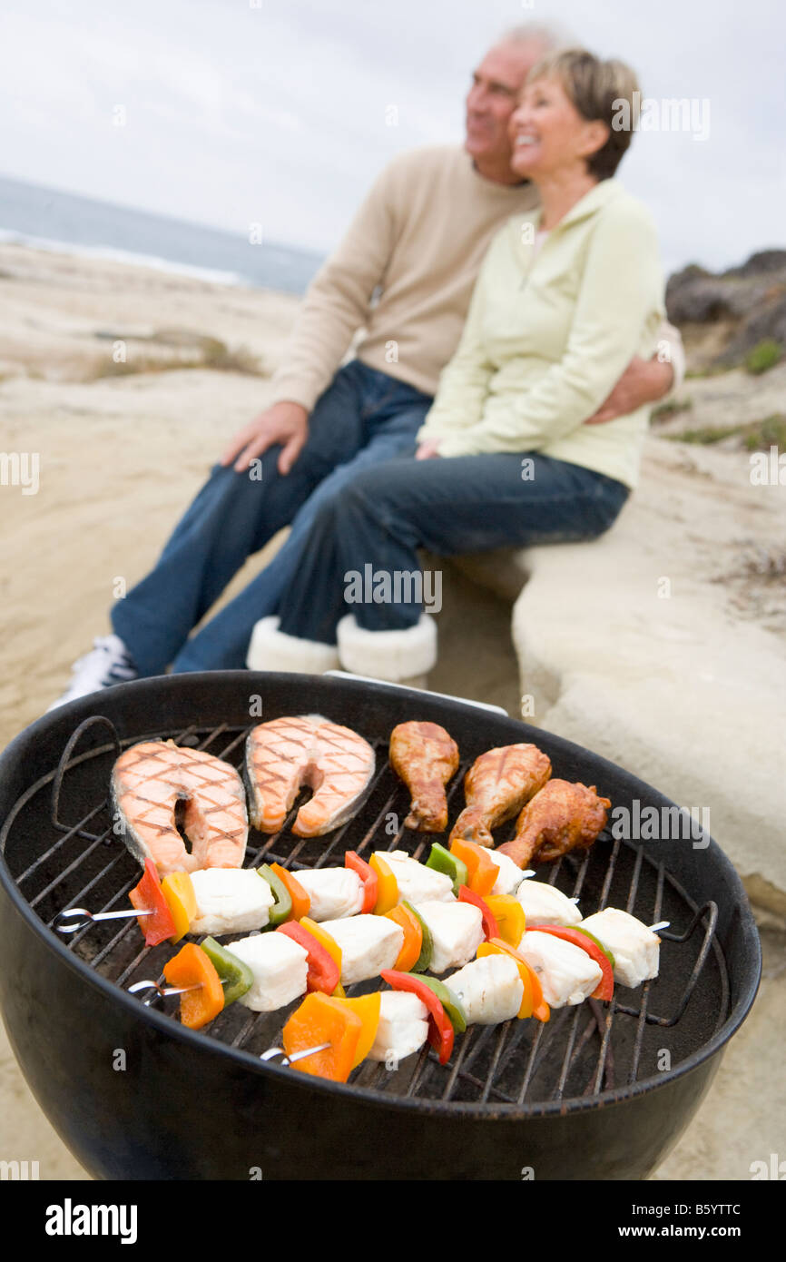 Couple Cooking On A Barbeque Stock Photo
