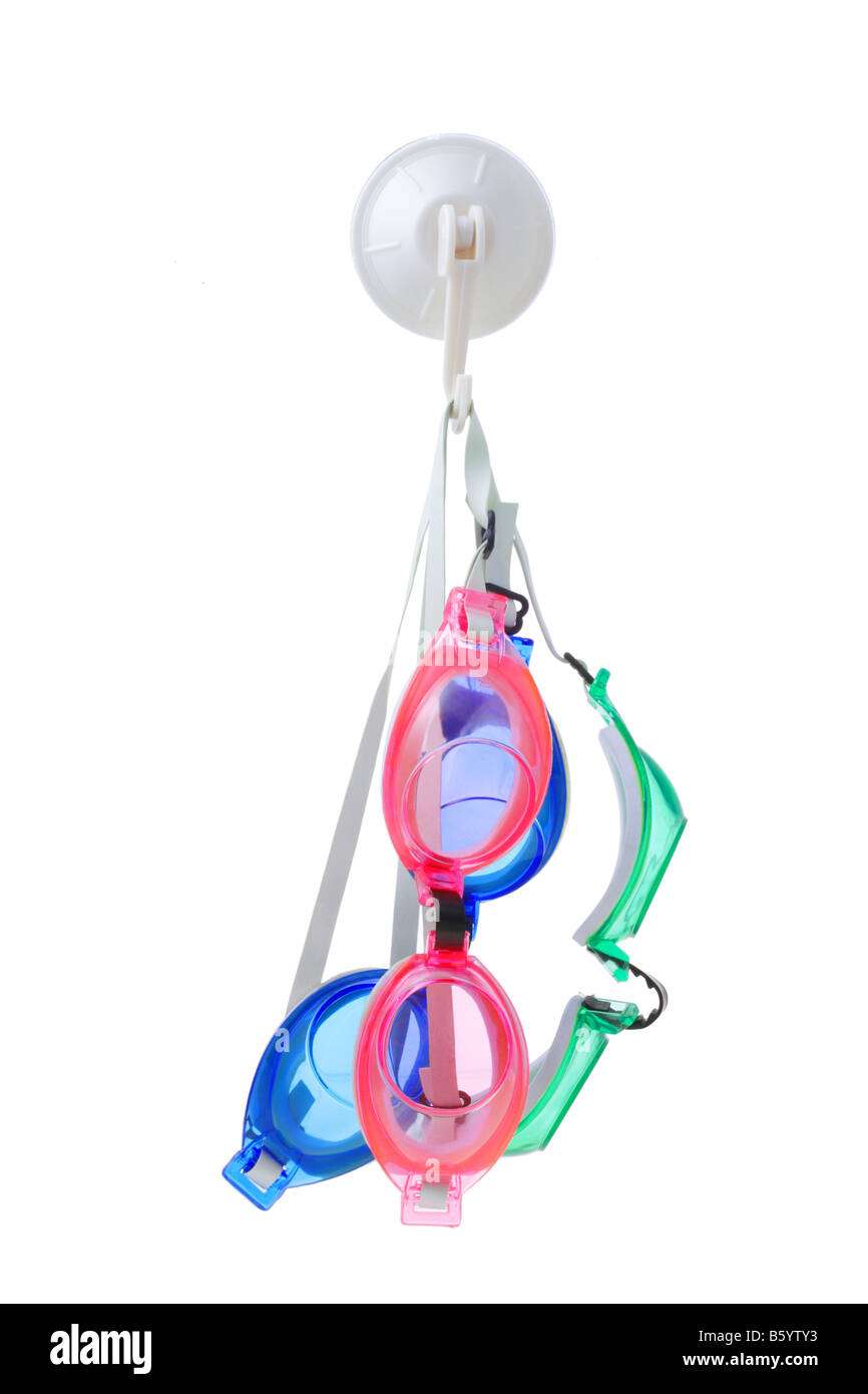 Three swimming goggles suspended on wall hook Stock Photo
