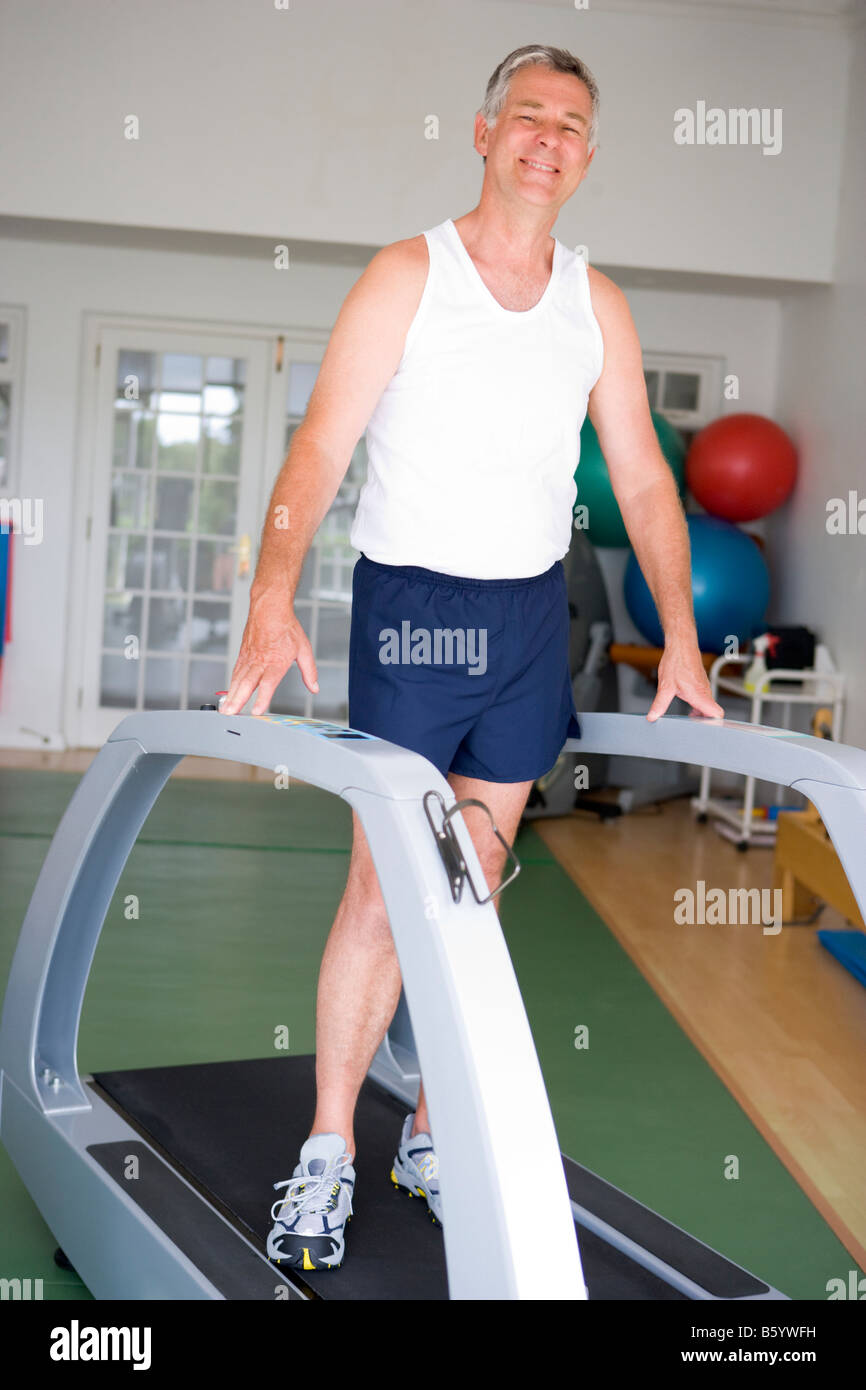 Man Running On Treadmill At Gym Stock Photo