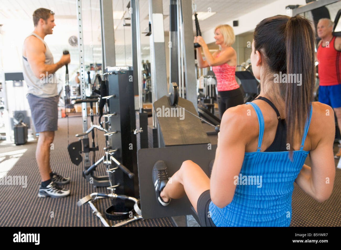 Group Of People Weight Training At Gym Stock Photo