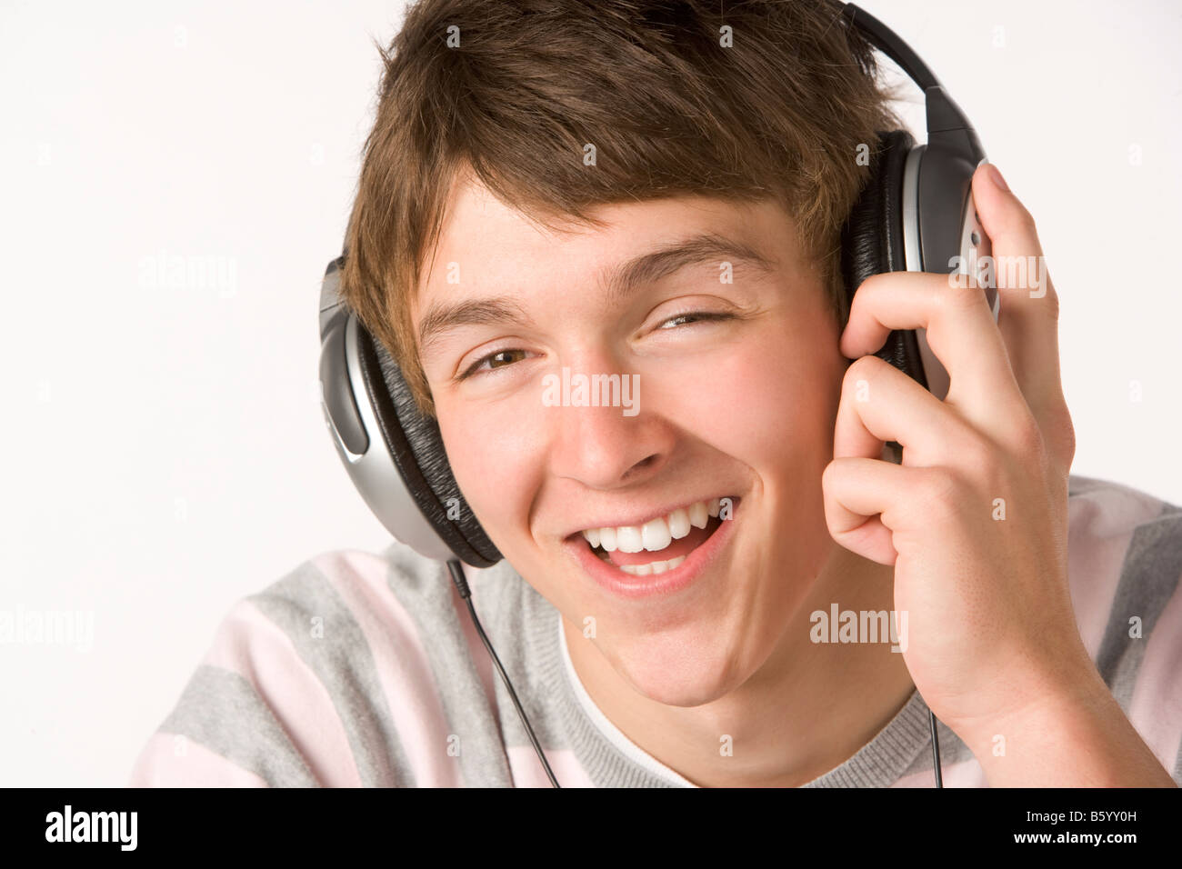 Teenage Boy Listening To Music On Headphones Stock Photo