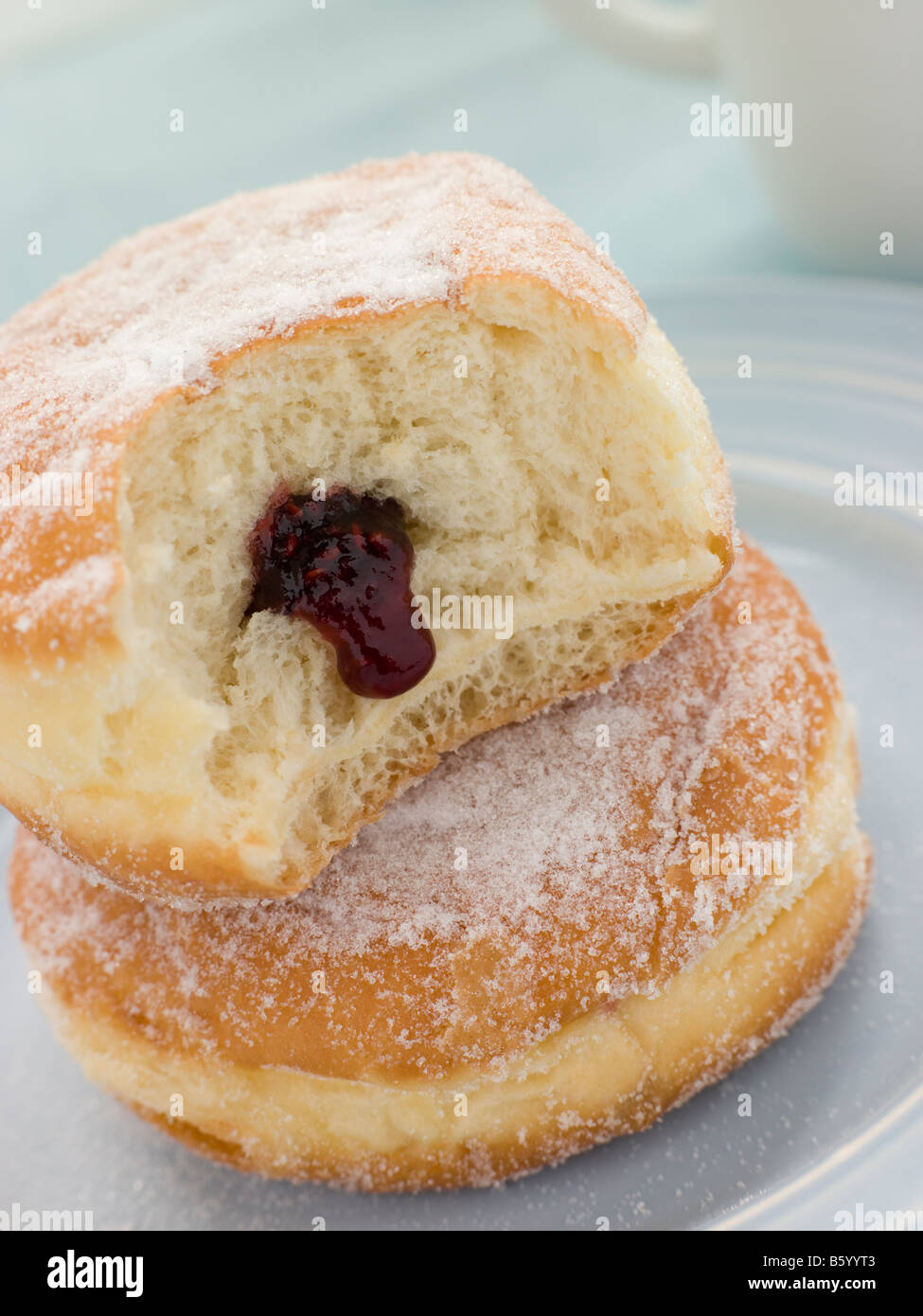 Two Raspberry Jam Doughnuts with a bite Stock Photo