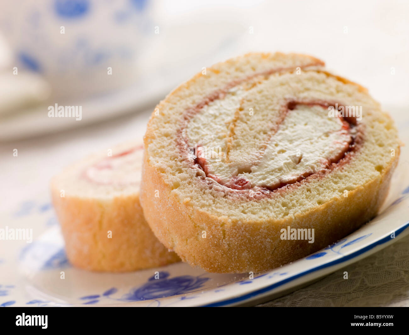 Cream and Strawberry Sponge Roll with Tea Stock Photo