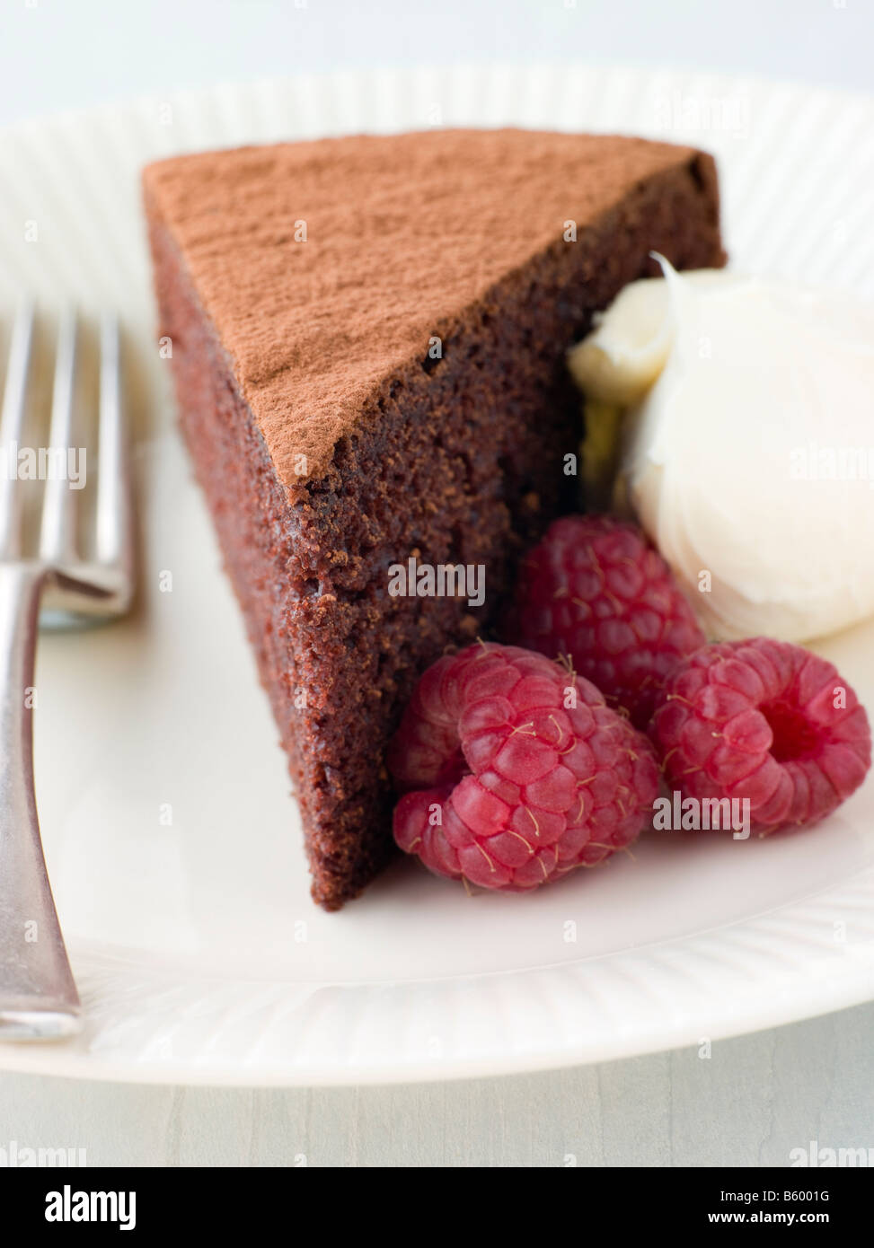 Chocolate Sponge with Whipped Cream and Raspberries Stock Photo