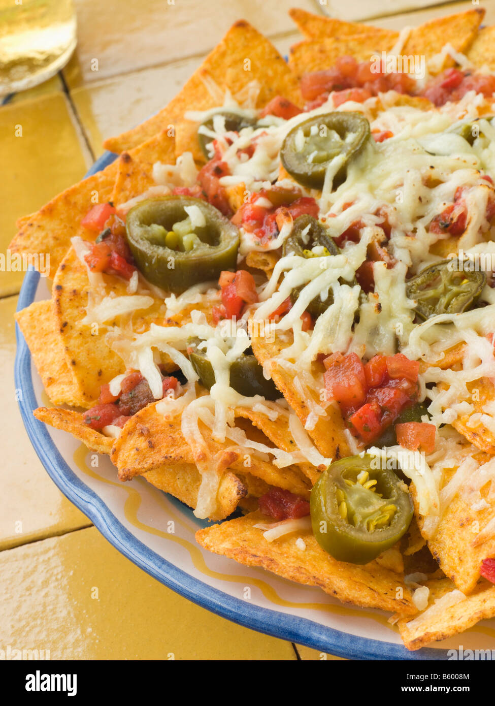 Platter of Nachos with Salsa Jalapenos and Cheese Stock Photo Alamy