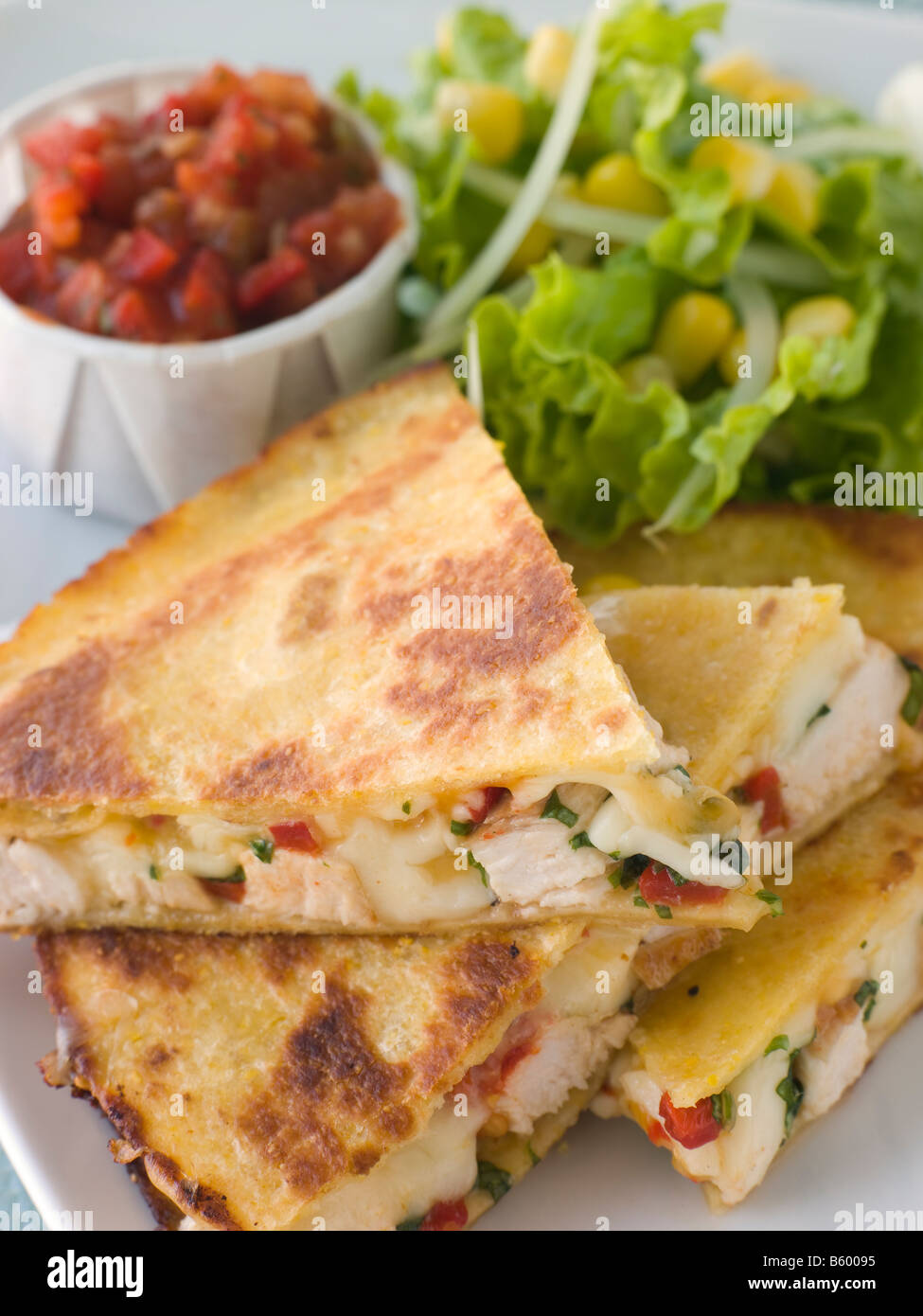 Quesadillas with Cajun Chicken Cheese Tomato Salsa and corn Salad Stock Photo