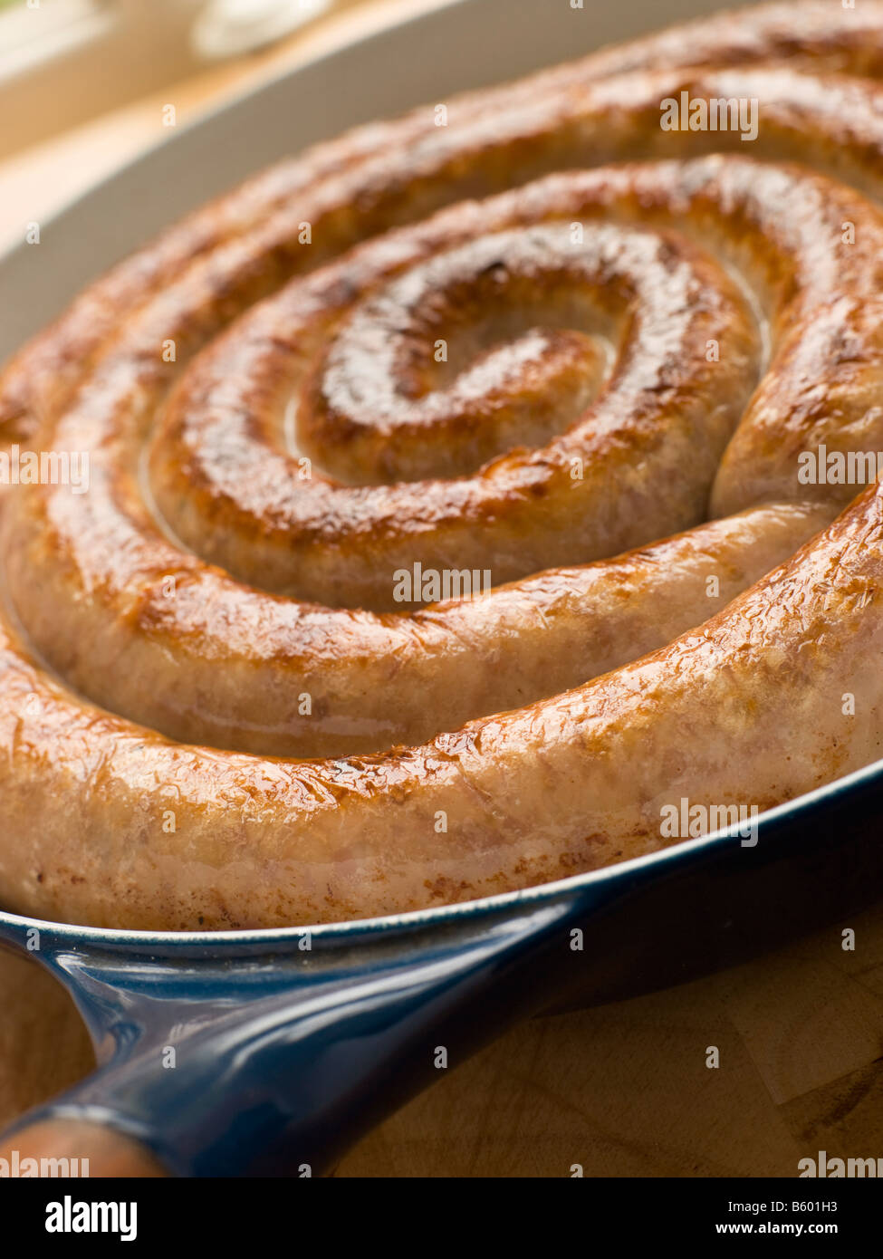 Cumberland Sausage Coil in a Frying Pan Stock Photo Alamy