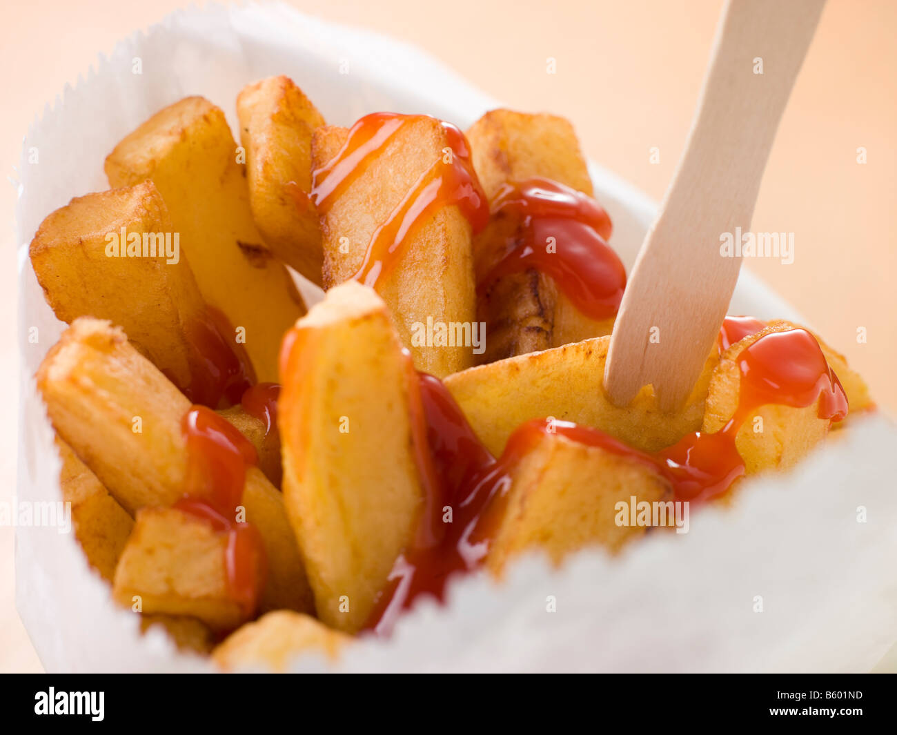 Chip Shop Chips in a Bag with a Wooden Fork and Tomato ketchup Stock