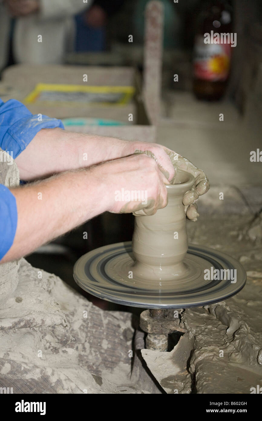 Marginea Romania Man throwing a clay pot using potter s wheel in a