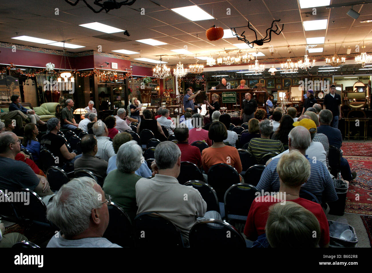 Antiques auction house with evening auction in progress Stock Photo Alamy