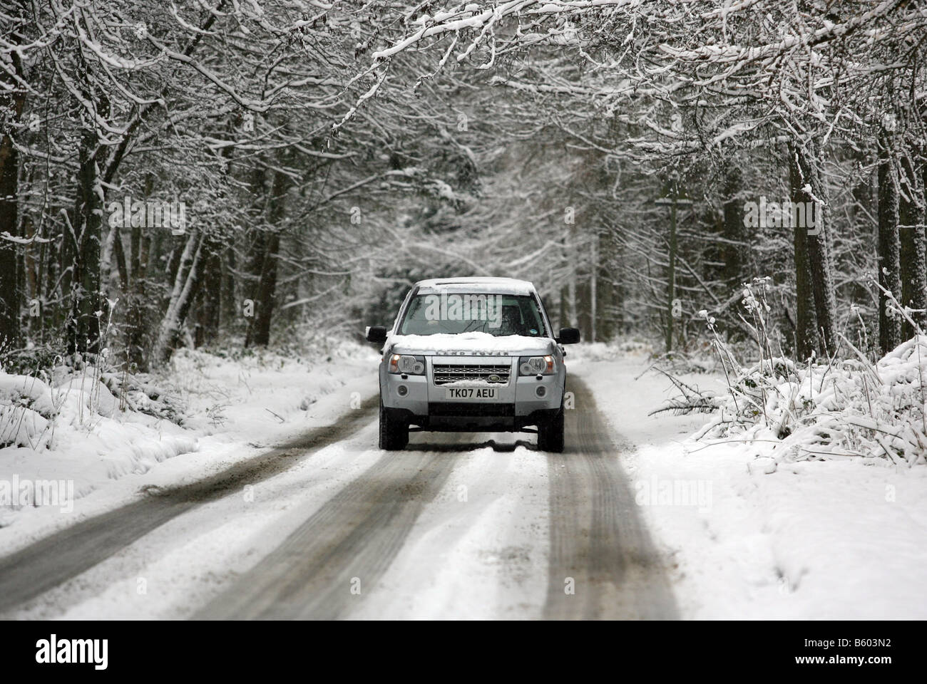 Land Rover Freelander 2 four wheel drive vehicle driving along a snow covered rural road in winter, in Scotland, UK Stock Photo