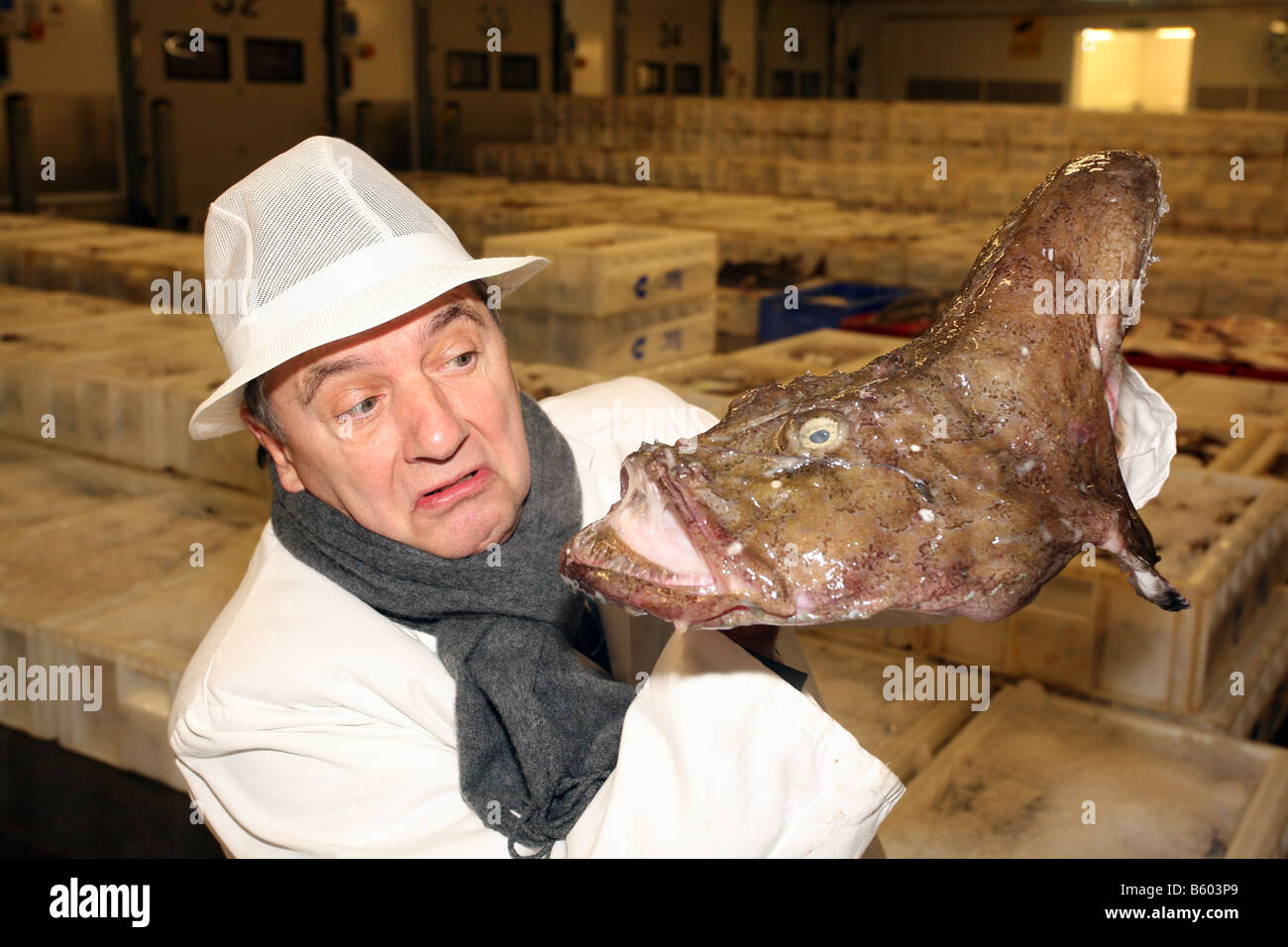 Famous French chef Raymond Blanc holding a monkfish at Peterhead fish market in Aberdeenshire, Scotland, UK Stock Photo