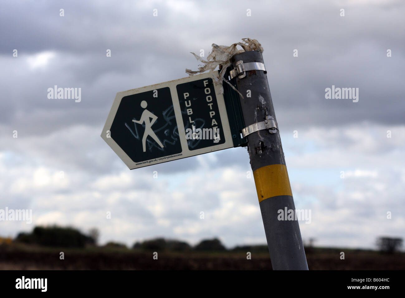 An unkempt footpath sign in Kent in the UK Stock Photo