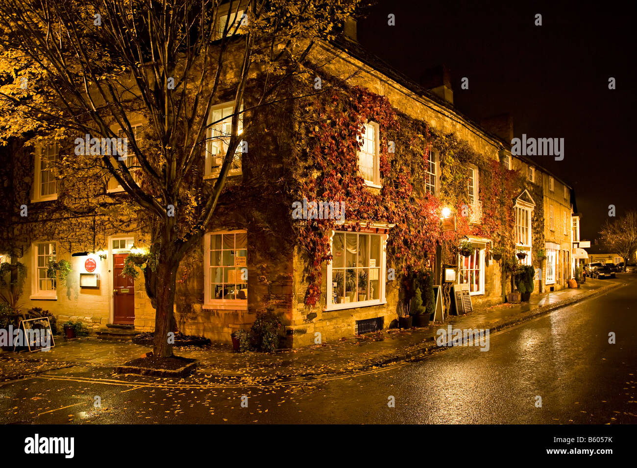 Street scene at night with virginia creeper across old buildings in centre of Woodstock Oxfordshire England UK Stock Photo