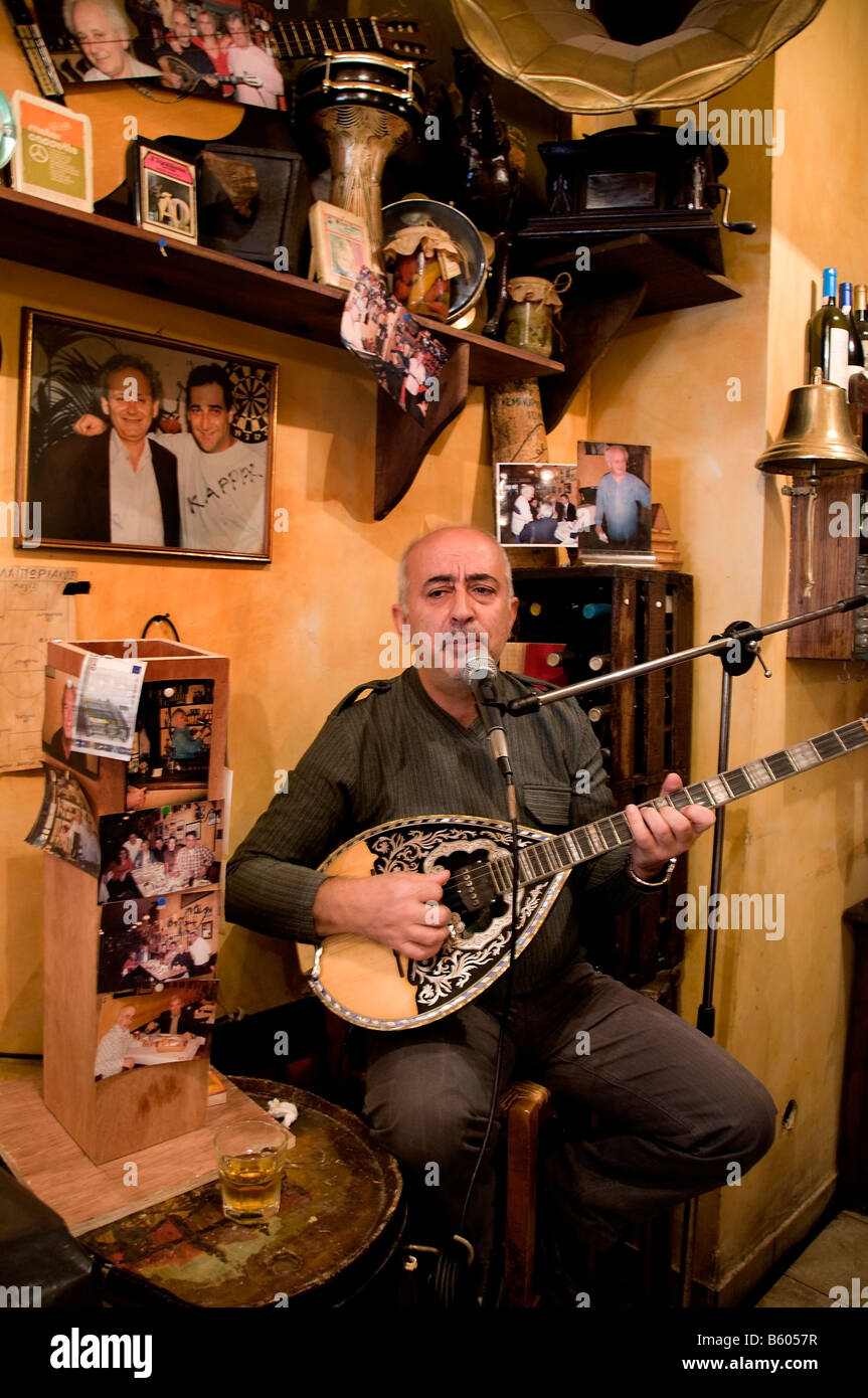 Inside a local cafe in Piraeus chaos music sitar drink cafe bar man woman  Athens Greek Greece Stock Photo - Alamy