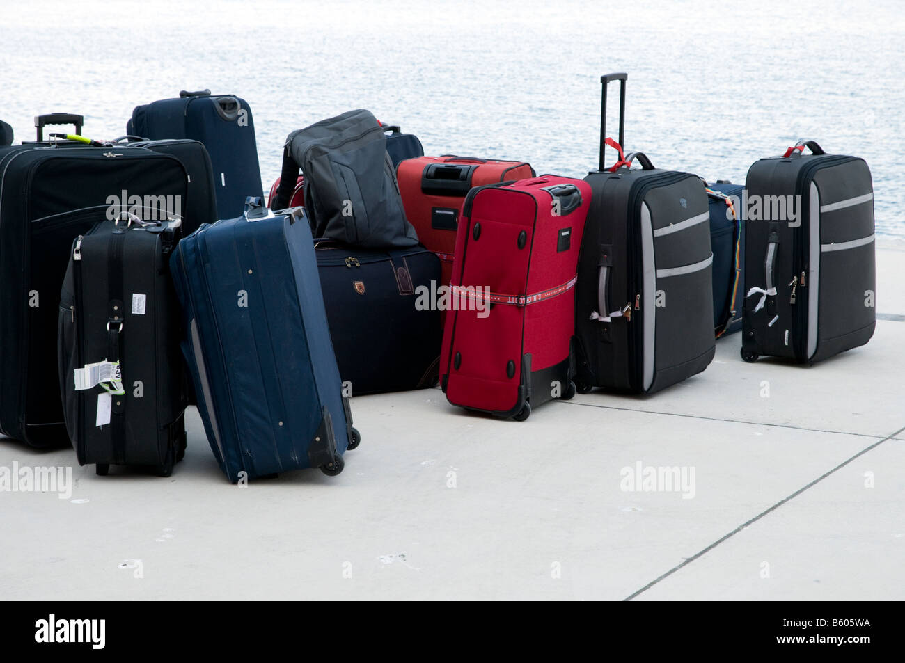 Suitcases on quayside waiting to be loaded onto a cruise ship Stock