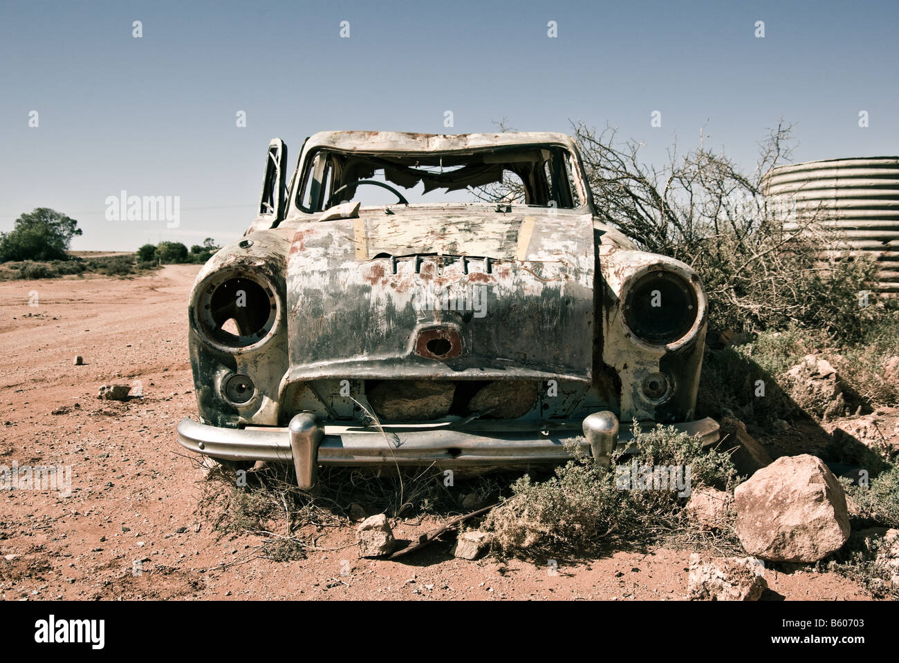 an old car in the desert rusts away Stock Photo