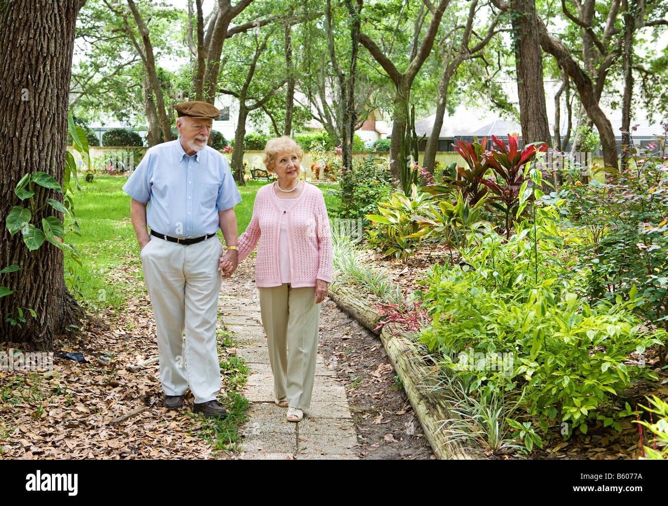 Couple walking together through garden hi-res stock photography and ...