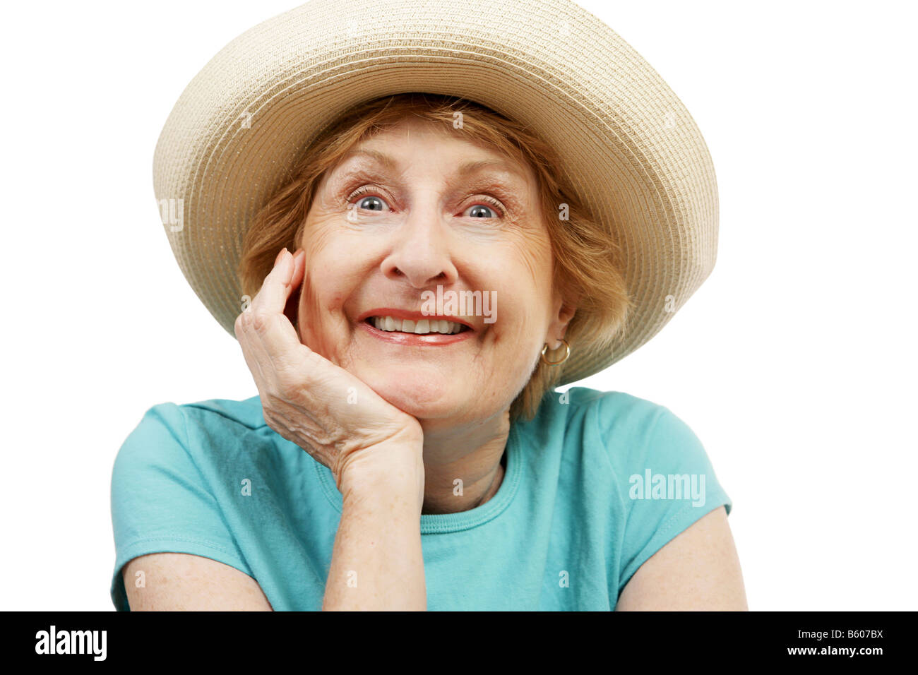 A very excited senior lady in a straw sun hat Isolated on white Stock Photo