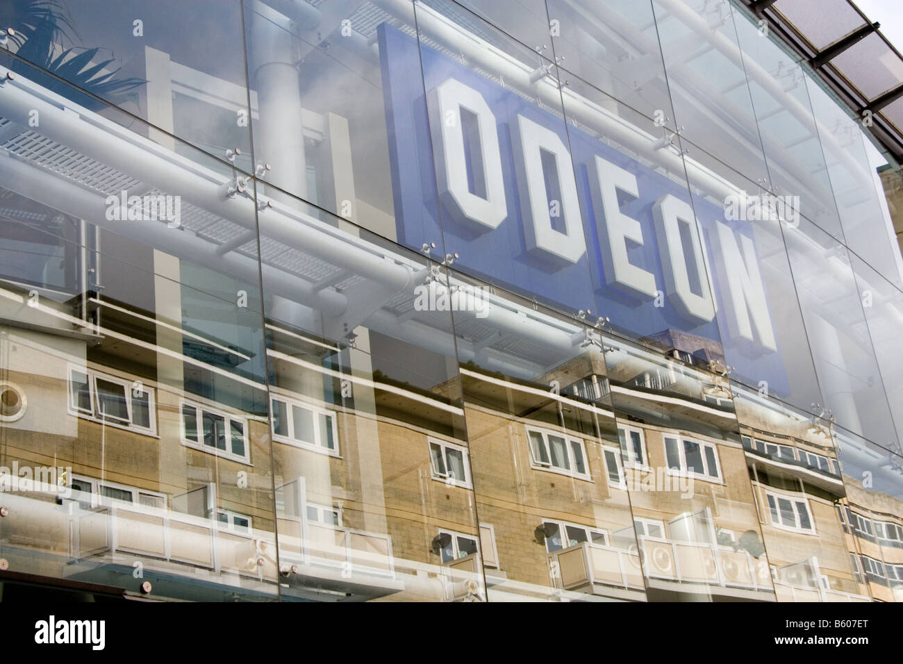 The glass frontage of the Odeon cinema complex in Bath, England with distorted reflections of nearby housing Stock Photo