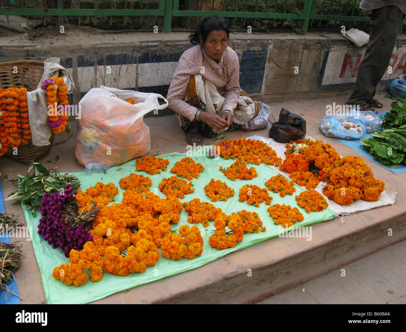 Flower seller at the early morning market in the Tahity Chowk area of Kathmandu, Nepal. Stock Photo