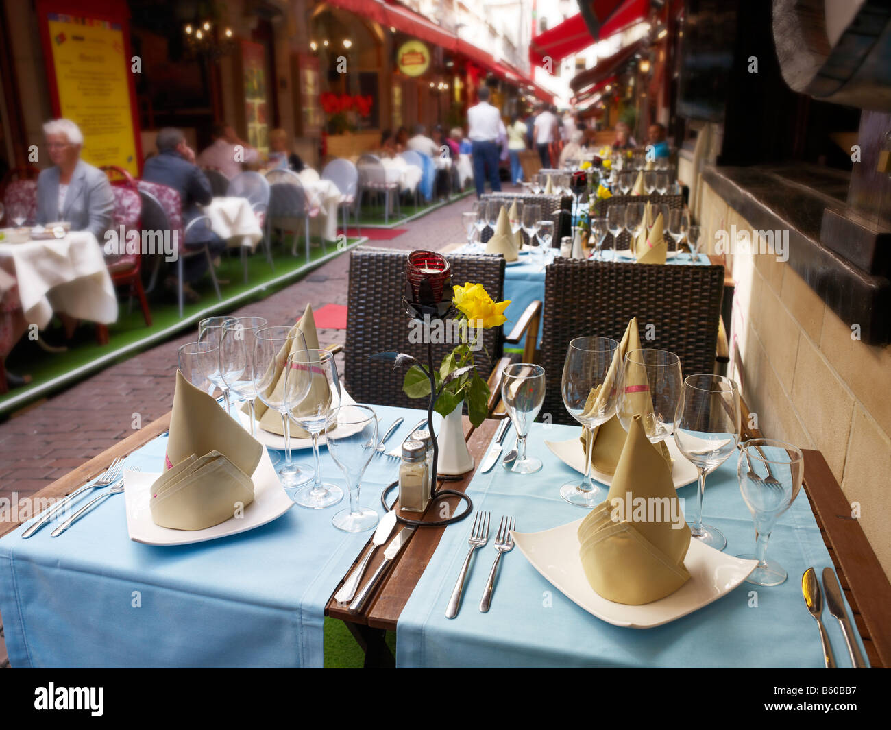 alleyway in old town with restaurants, well-laid table in front, Brussels, Brabant, Belgium Stock Photo
