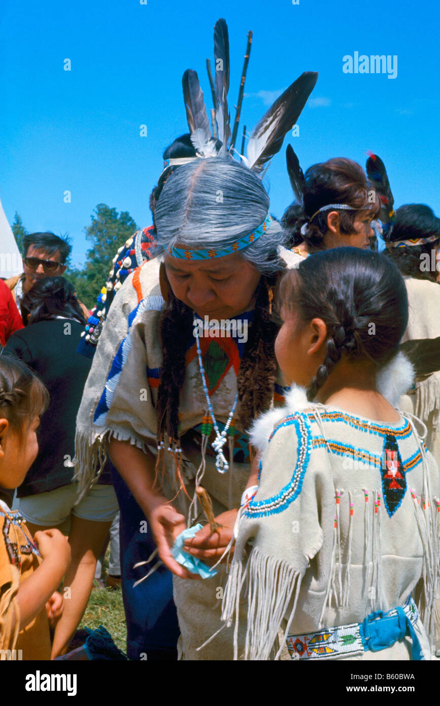 Native American Indian Family celebrating at a Pow Wow in Traditional Regalia Stock Photo