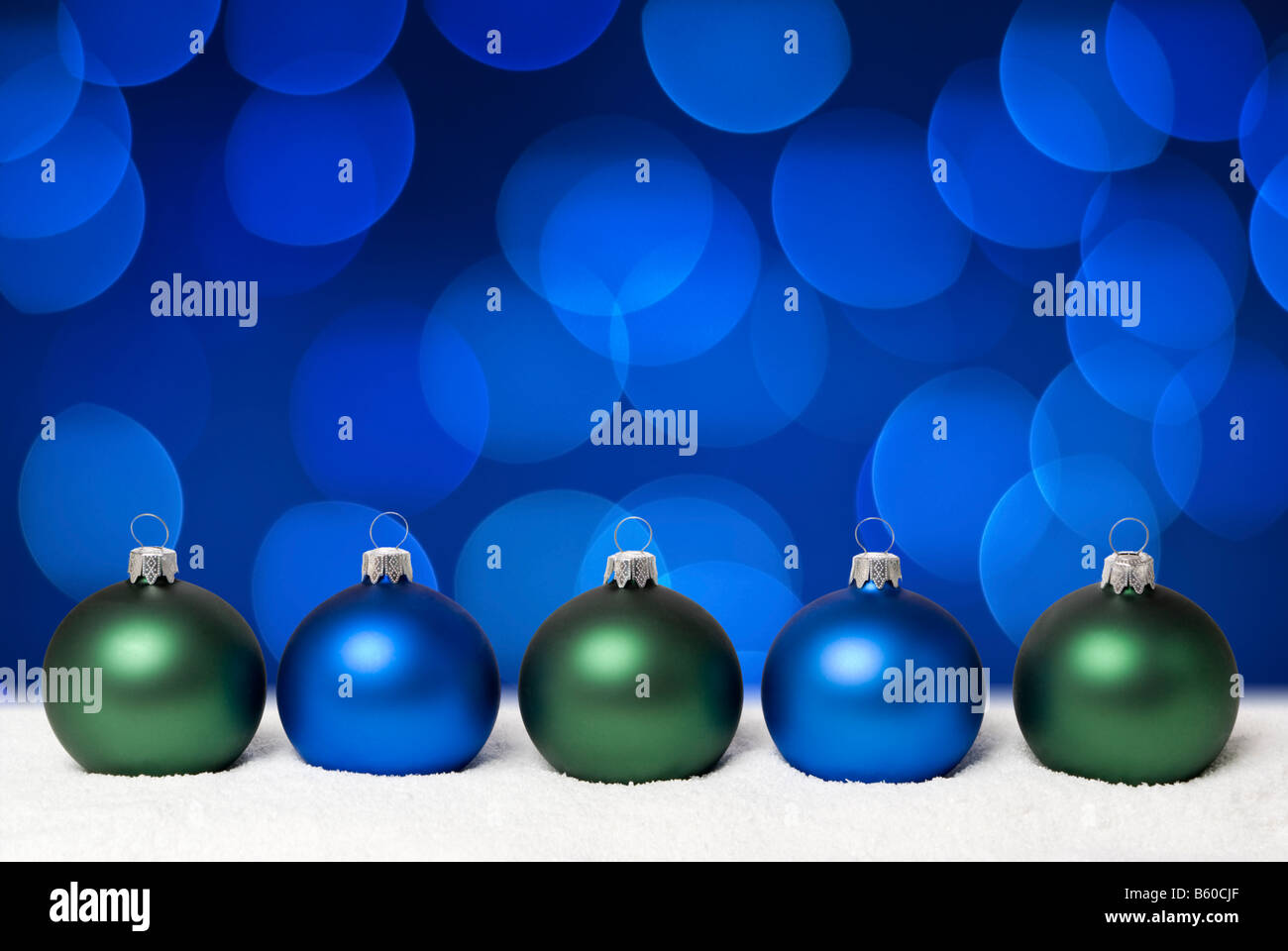 Christmas balls on the snow. Background blue christmas lights. aRGB