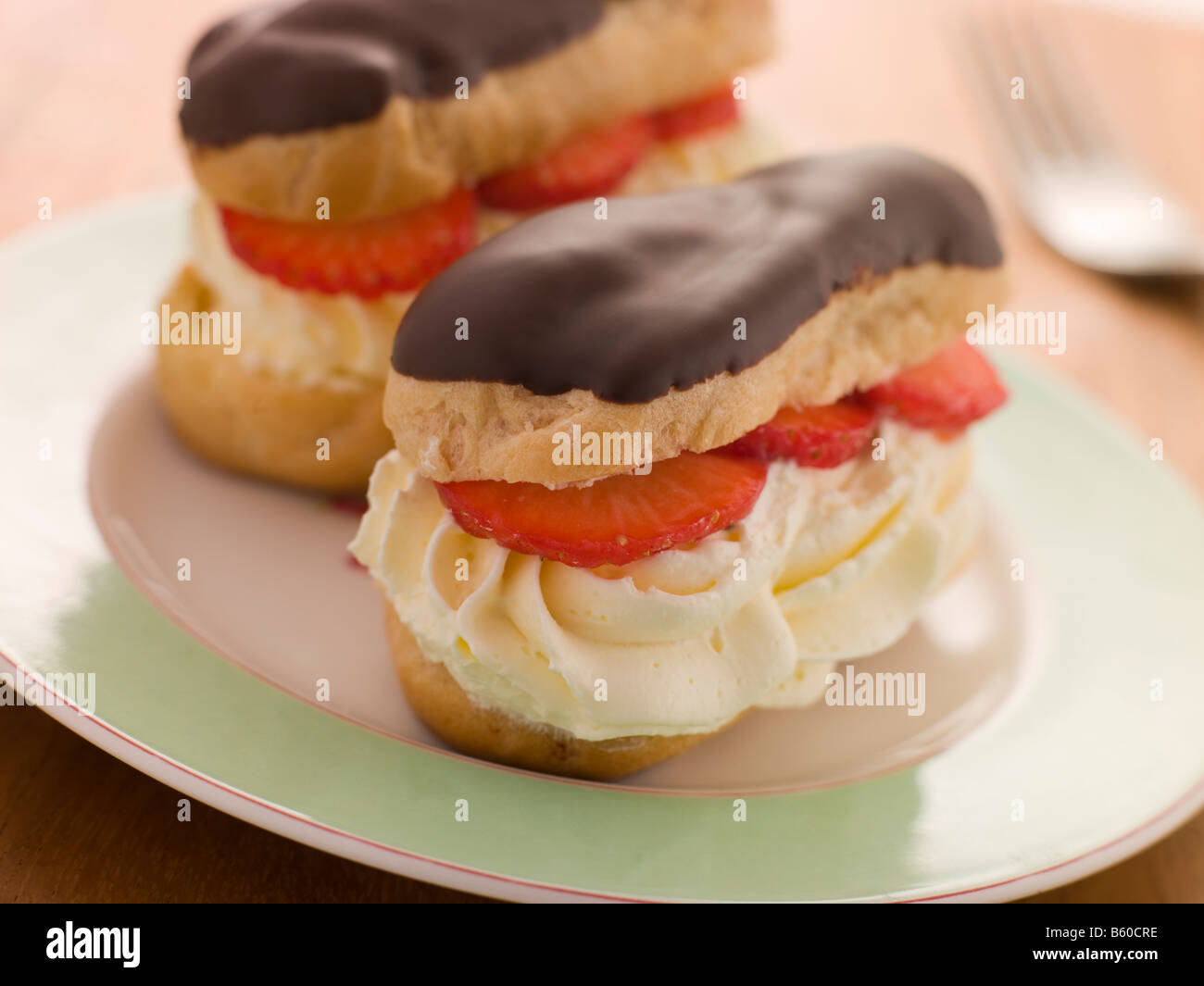 Chocolate and Strawberry filled eclairs Stock Photo