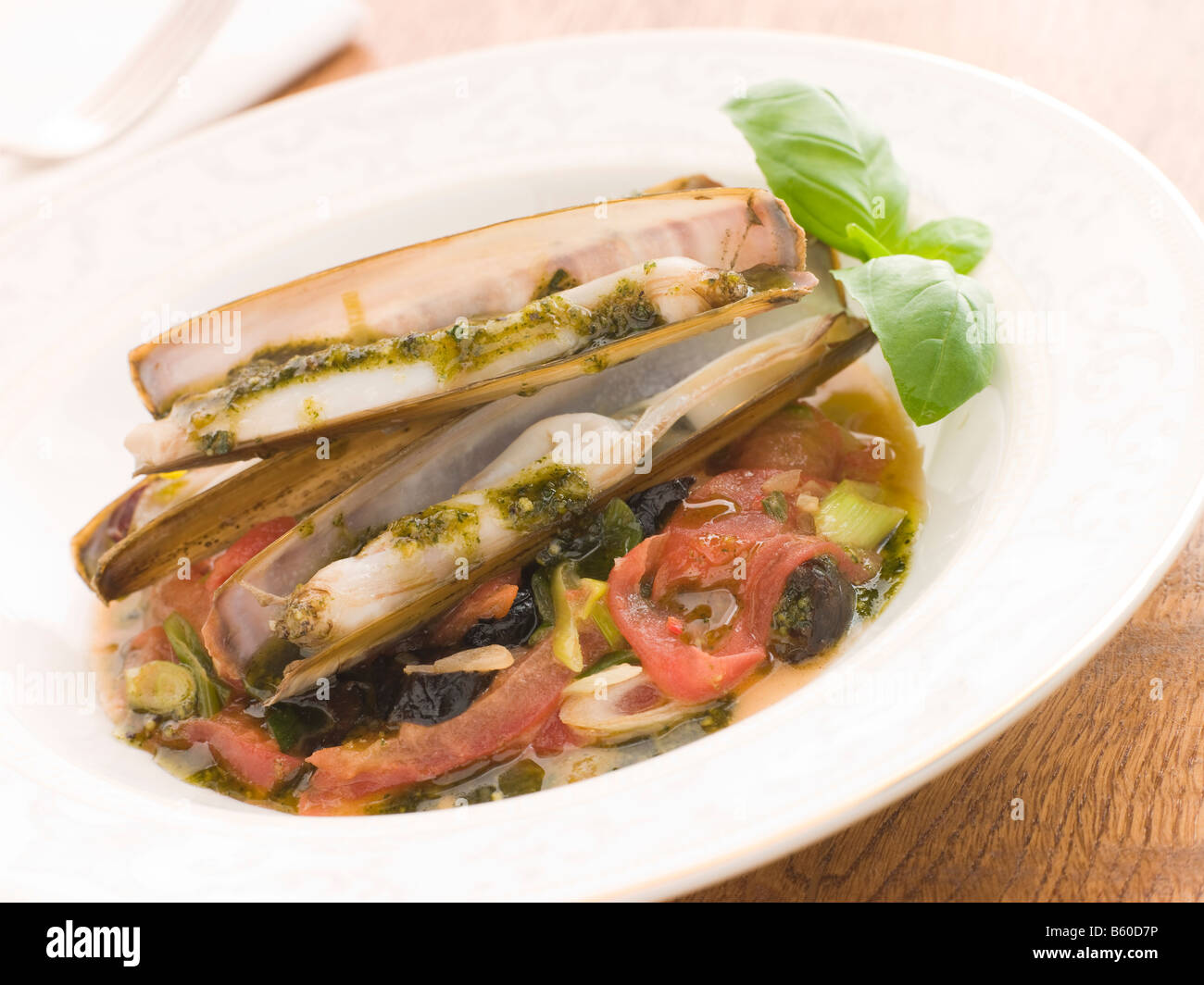 Razor Clams with Stewed Tomatoes Garlic and Olives Stock Photo