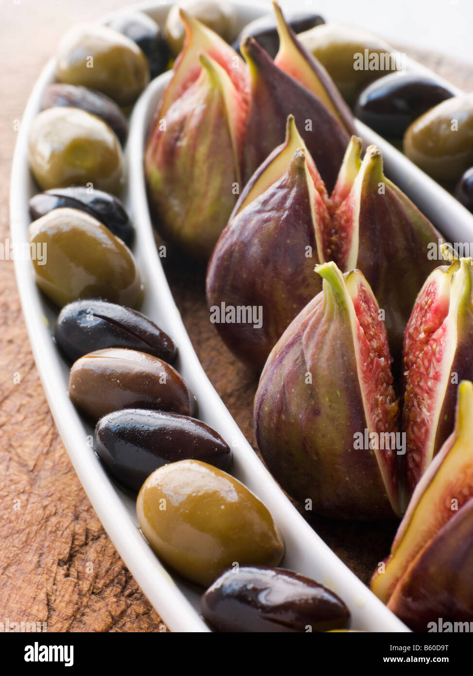 Dish of Green and Black Olives with Fresh Figs Stock Photo Alamy