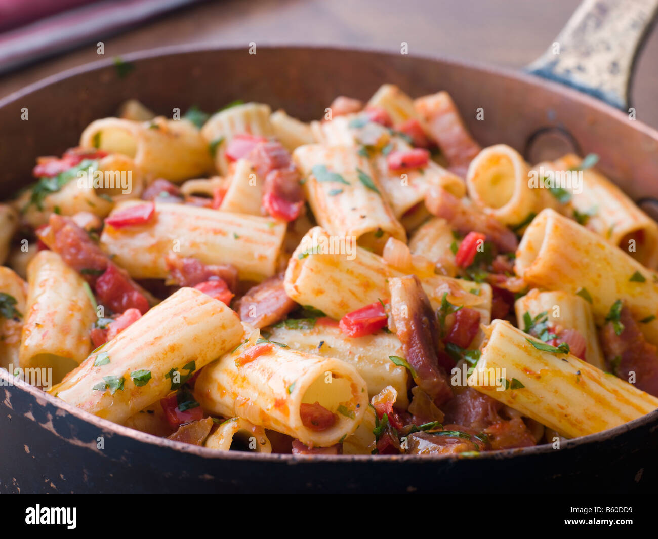 Pan of Rigatoni Pasta with Tomato and Pancetta Sauce Stock Photo