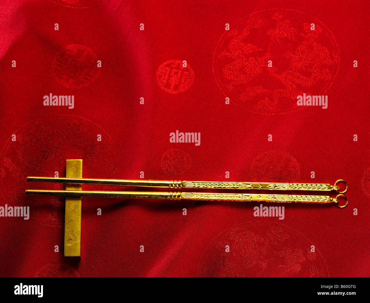 a pair of golden chopsticks and chopsticks rest Stock Photo Alamy