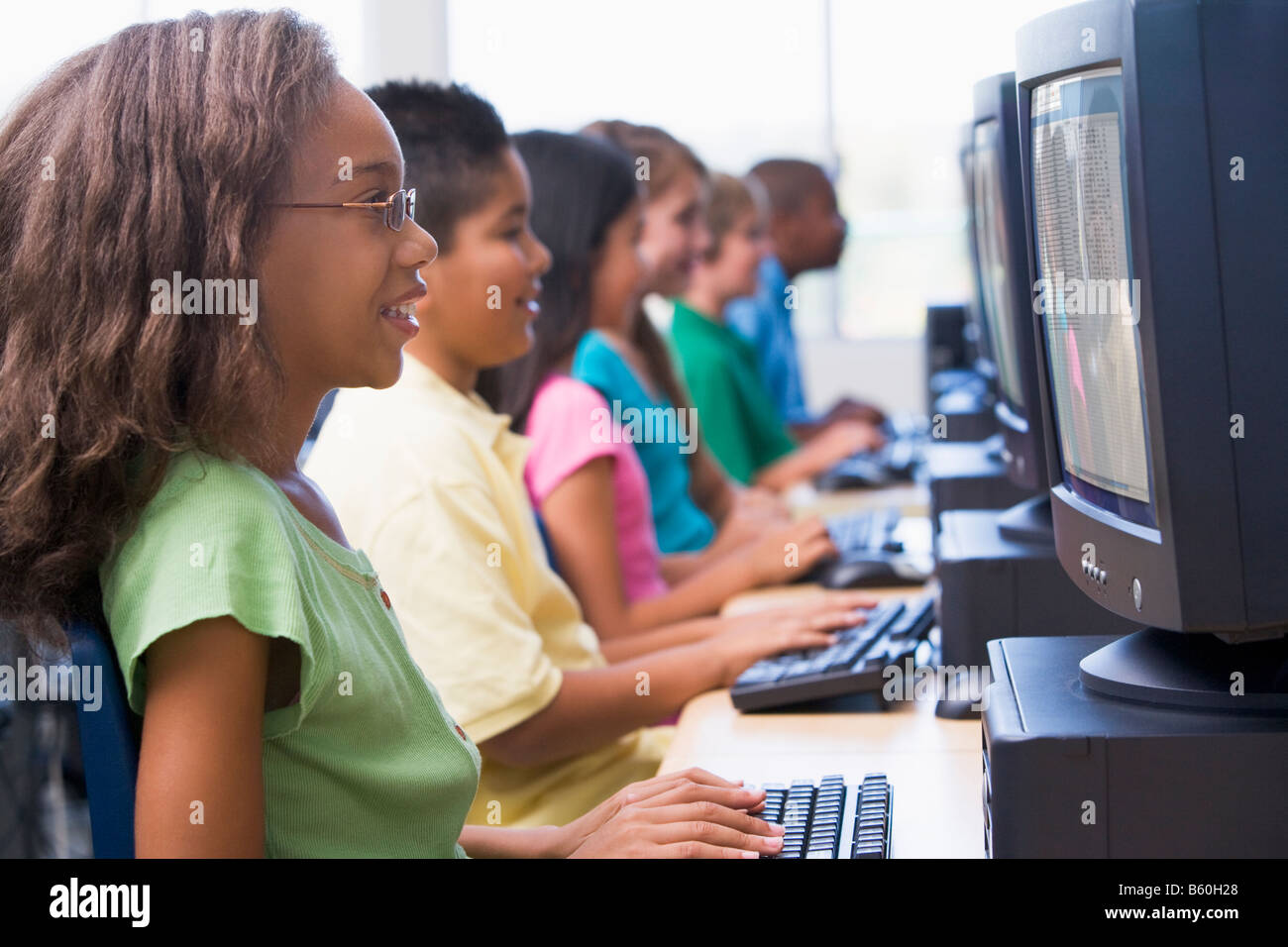 Six children at computer terminals hires stock photography and images