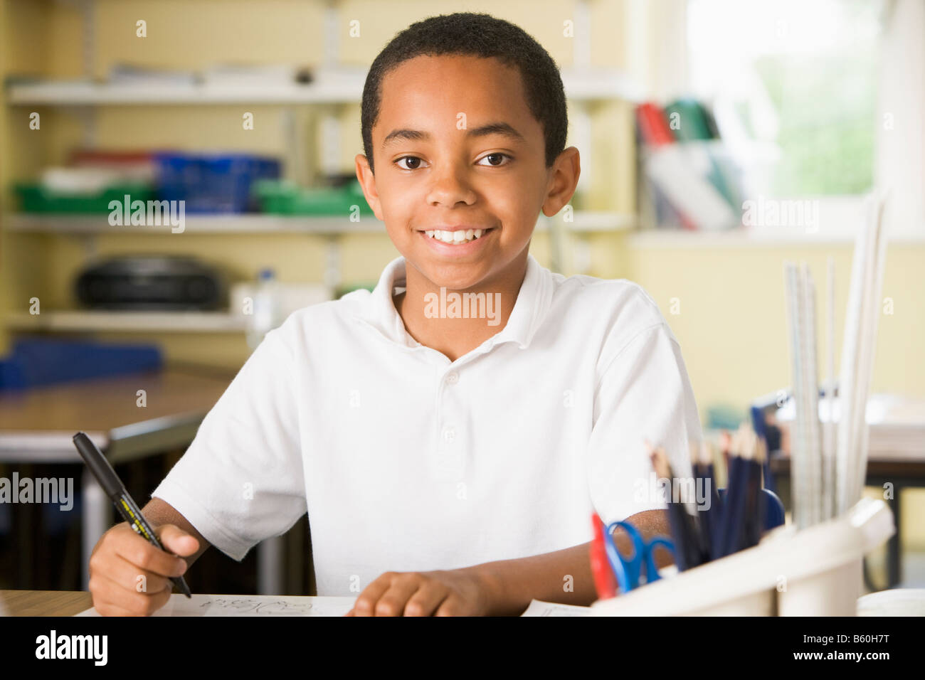 Student in class taking notes Stock Photo