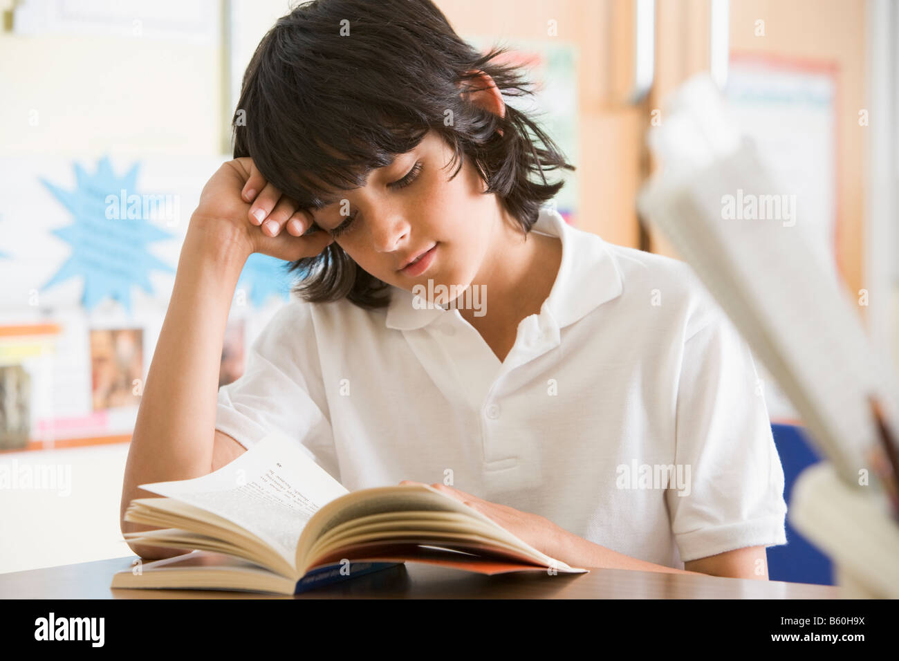 Student in class reading book (selective focus) Stock Photo