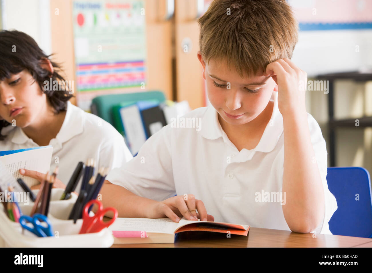 Students in class reading books Stock Photo