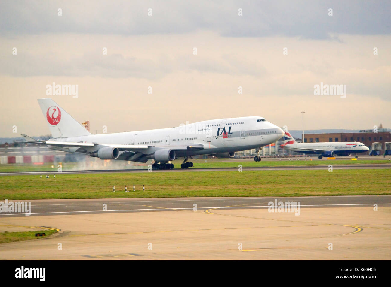 A Jumbo jet Boeing 747 landing on a runway at Heathrow. Stock Photo