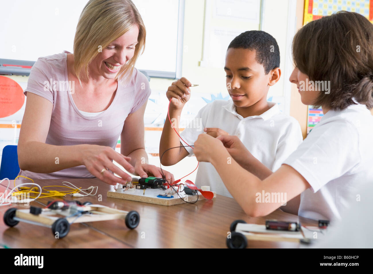 Students in class with teacher making electronic cars Stock Photo