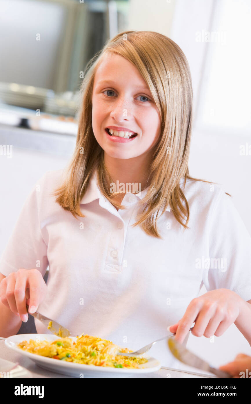Student in cafeteria eating lunch (selective focus) Stock Photo