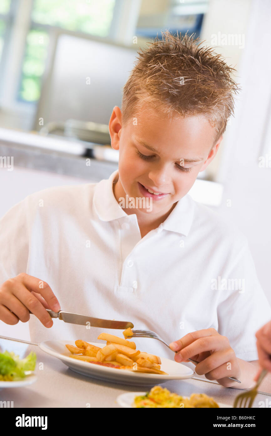 Student in cafeteria eating lunch (selective focus) Stock Photo