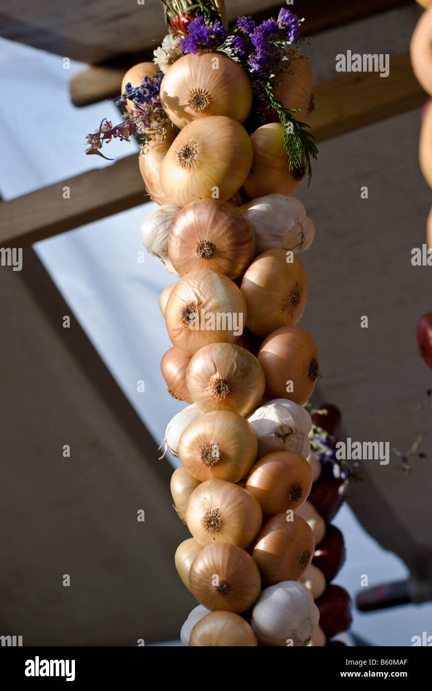 Strand of braided onions with decorative flowers at the annual onion festival, Bern, Switzerland Stock Photo