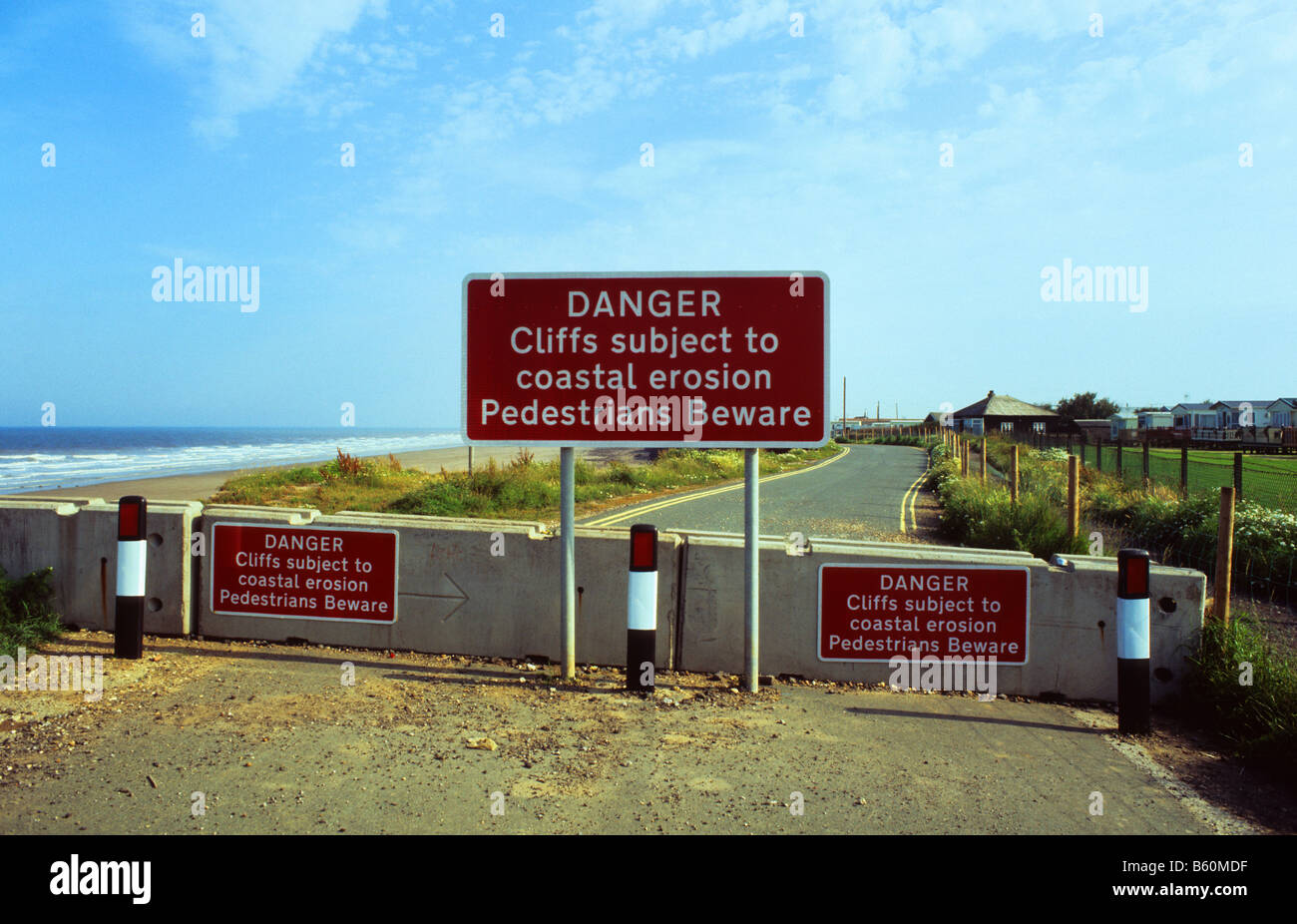 warning sign of coastal erosion and disapearing coastal road at Skipsea East coast of Yorkshire UK Stock Photo