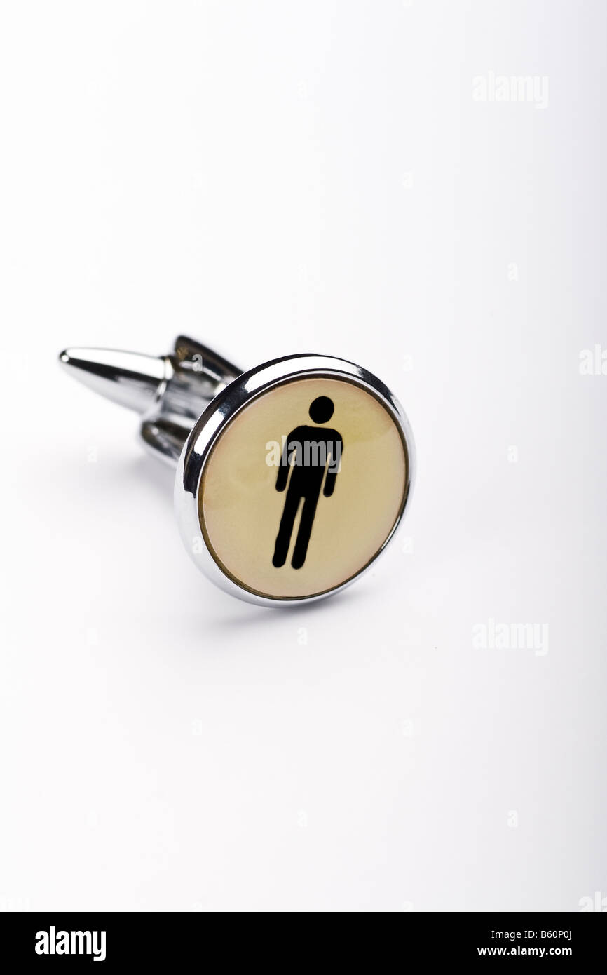 a cufflink with a black silhouette of a man Stock Photo