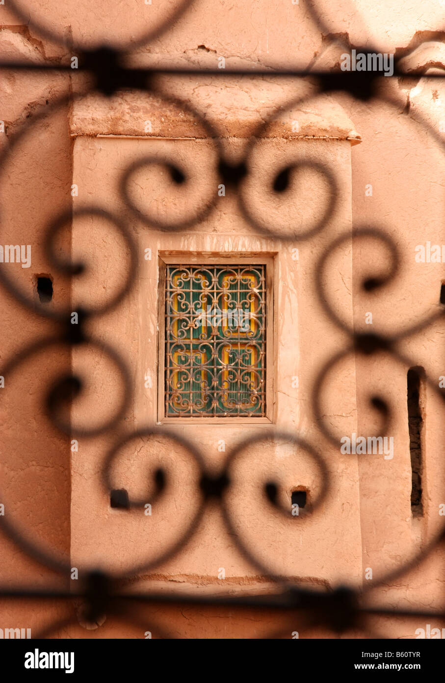 Window seen through a wrought iron grill in the Kasbah town of Ouarzazate Morocco Stock Photo