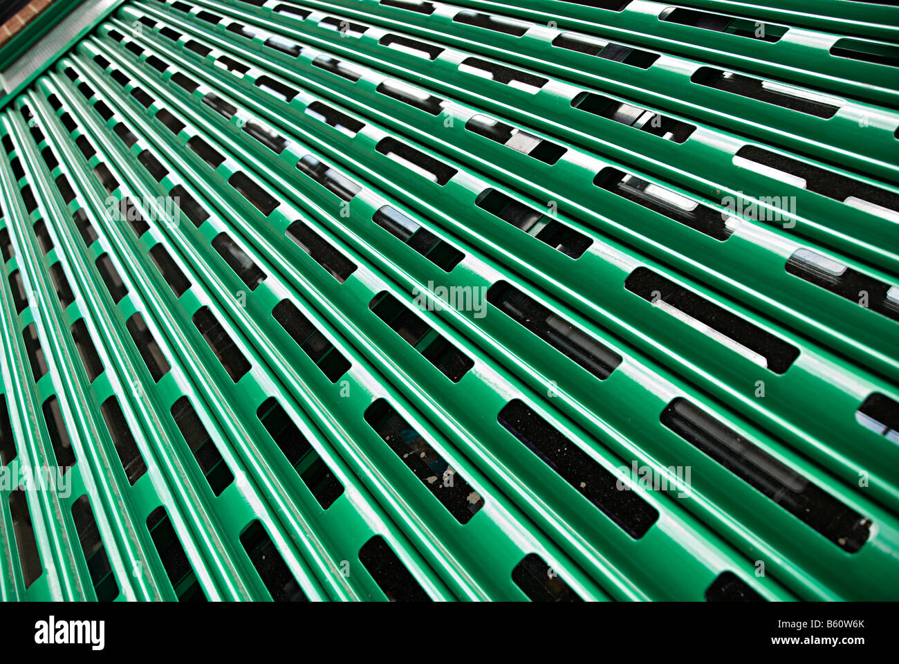 green shutters on a shop front to stop people breaking in Stock Photo