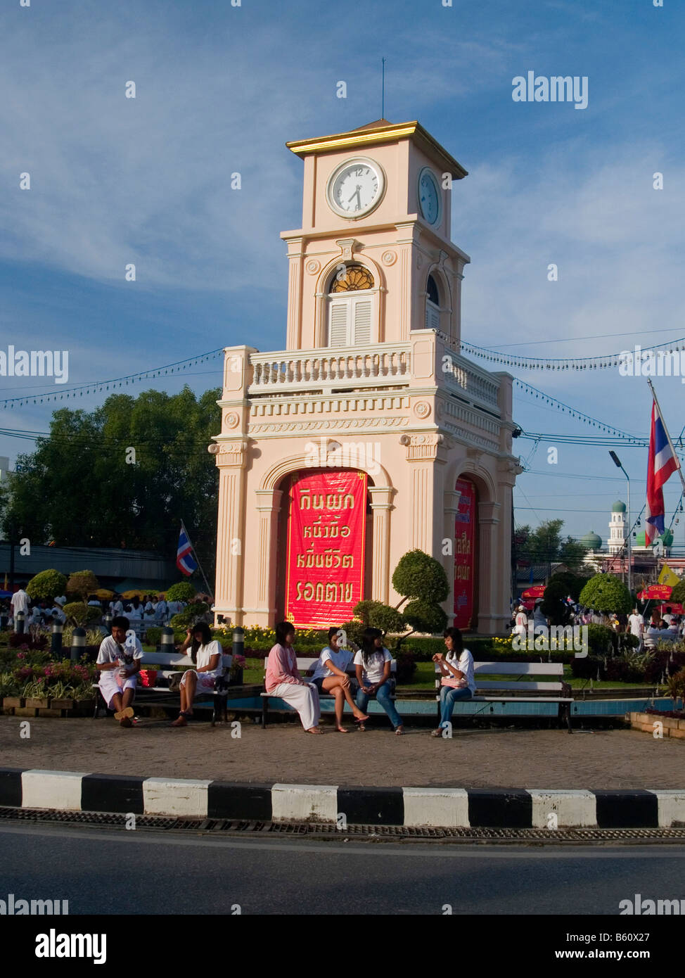sitting around the clocktower in Phuket Thailand Stock Photo