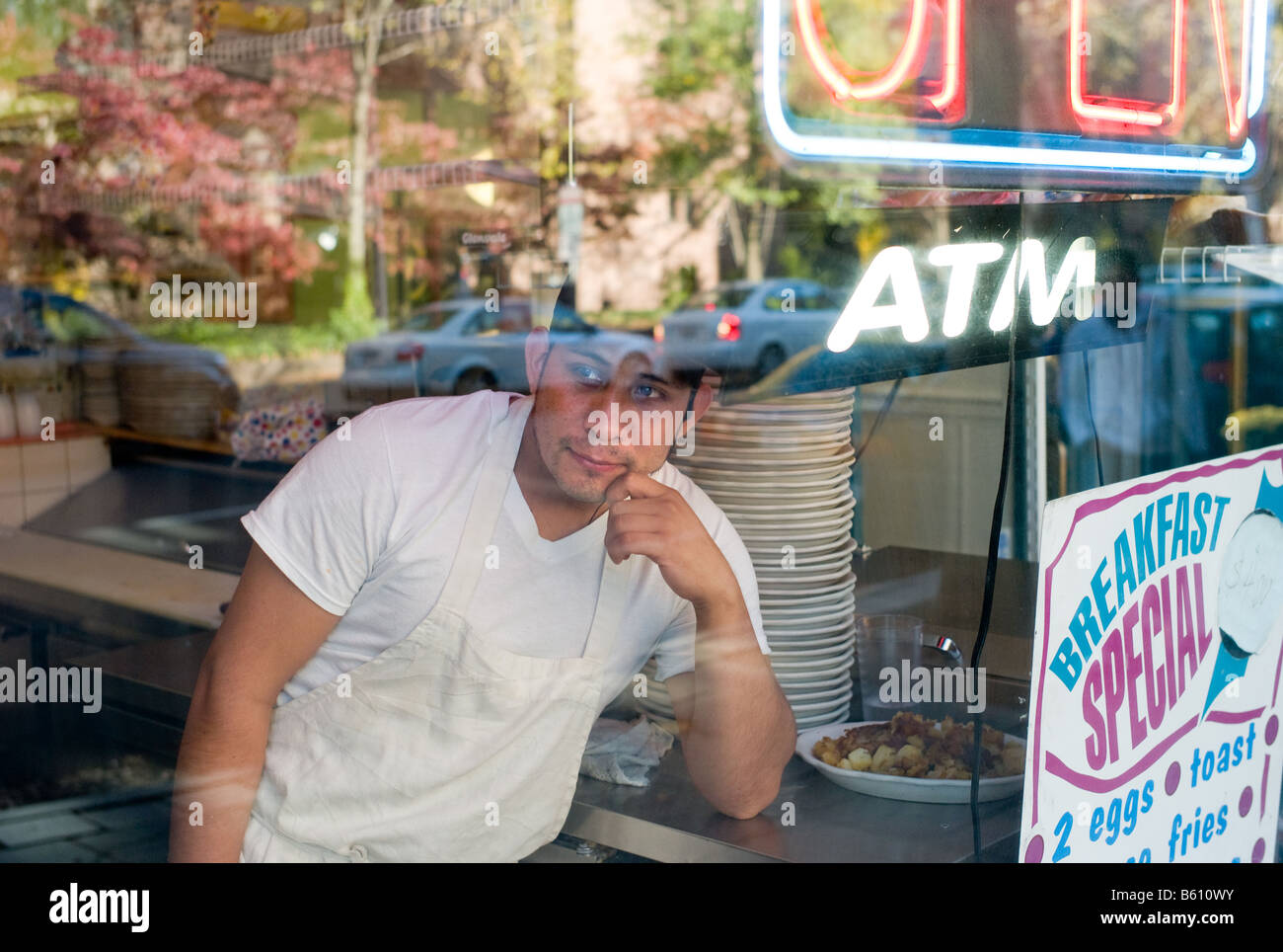 A cook looks out from the "Copper Kitchen" restaurant window in New