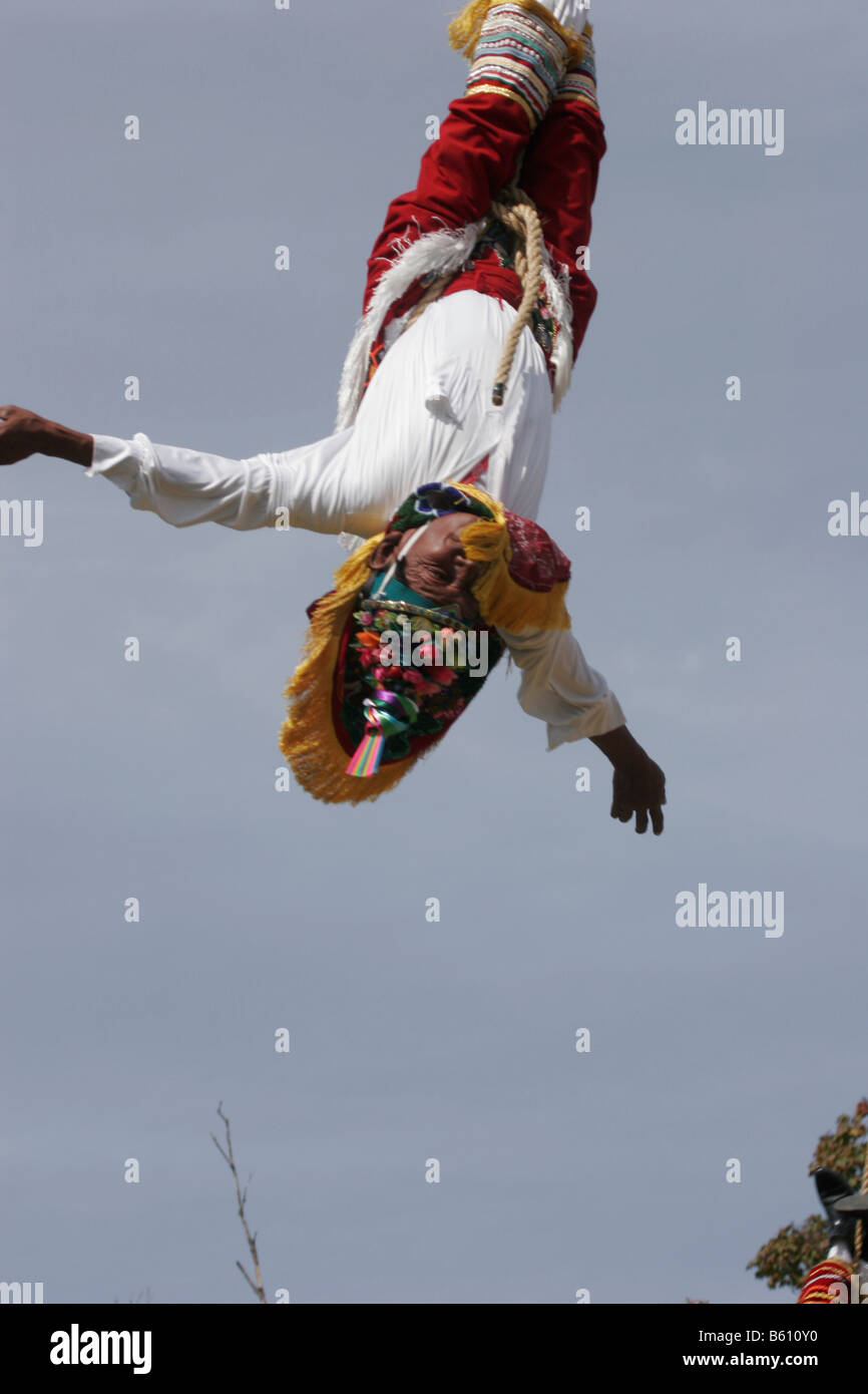 Member of the "Mayan flying man" Sundance group descending from a 90 ft pole suspended by a rope Stock Photo
